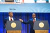 Chris Redd and New York City Mayor Eric Adams standing behind podiums.