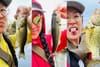 Our fishing columnist holds up some fish.