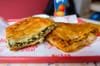 Spinach and cheese burek, $6.50, ground lamb and beef burek, $7.50, on a tray, for a closeup.