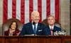 President Biden stands between Vice President Kamala harris and Speaker of the House Kevin McCarthy while delivering his stat