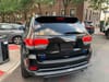 A black Jeep with an illegal plate obstruction device driven by the Brooklyn director of the Mayor's Community Affairs Unit.