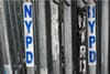 A police barricade with NYPD stickers.