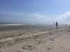 A sandy stretch of Rockaway Beach on a sunny day.