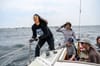 Members of the yacht collective yank pulleys and use walkie-talkies.