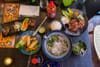 A table filled with classic Vietnamese dishes.