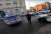 An NYPD SUV attempts to park on the sidewalk outside of a police precinct while an NYPD officer tells a cyclist to get out of