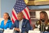 Eric Adams and senior staff sitting in front of an American flag in City Hall