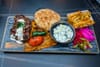 Lamb adana platter from Zyara, with fries, pickles, pita, and cucumbers in yogurt, $19.99