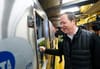 Richard Davey taps the subway conductor's window on a train.