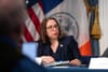Lisa Zornberg looks at a reporter asking a question during the mayor's weekly press conference.